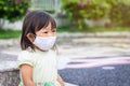 Happy Asian child girl smiling and wearing fabric mask. She playingÃ¢â¬â¹ at the playground. socialÃ¢â¬â¹ Distance. Learning and active Royalty Free Stock Photo